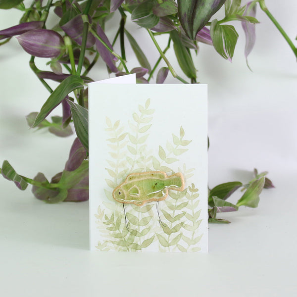 small ceramic and glass emerald green fish plant decoration, on gift card with watercolour leaves