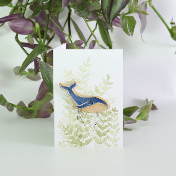 small ceramic and glass dark blue whale plant decoration, on gift card with watercolour leaves