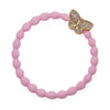 Bracelet élastique papillon doré sur rose tendre